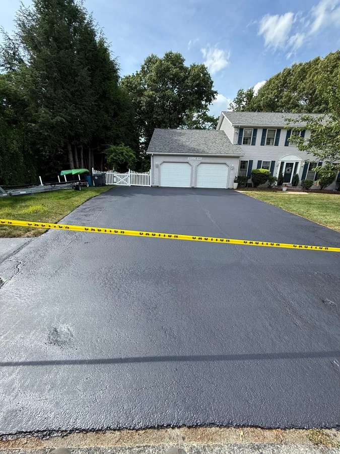 Wide residential driveway freshly sealed